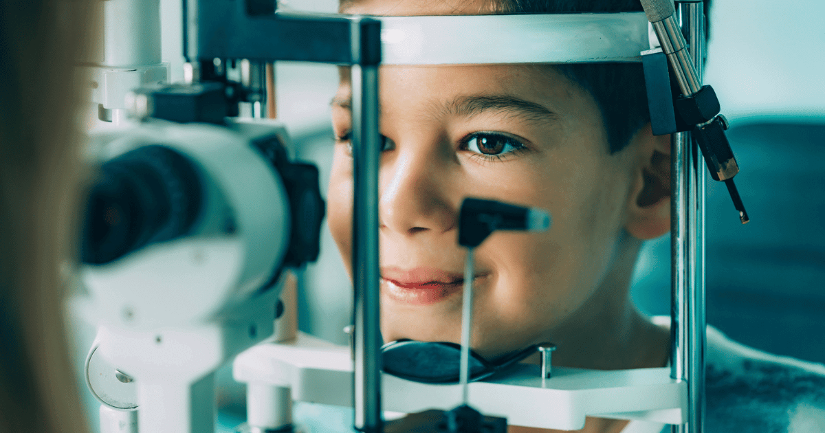 A young boy getting an eye exam after struggling in school.