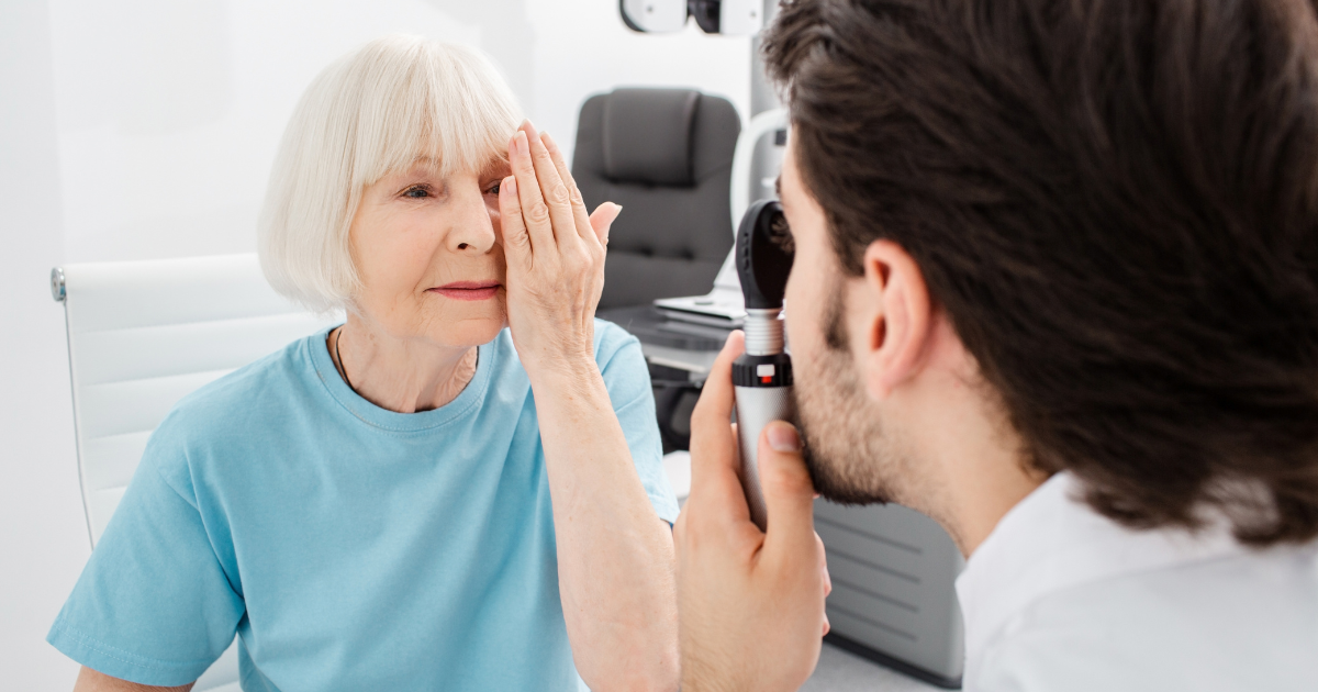 An older woman having her eyes examined to prepare for cataract surgery.