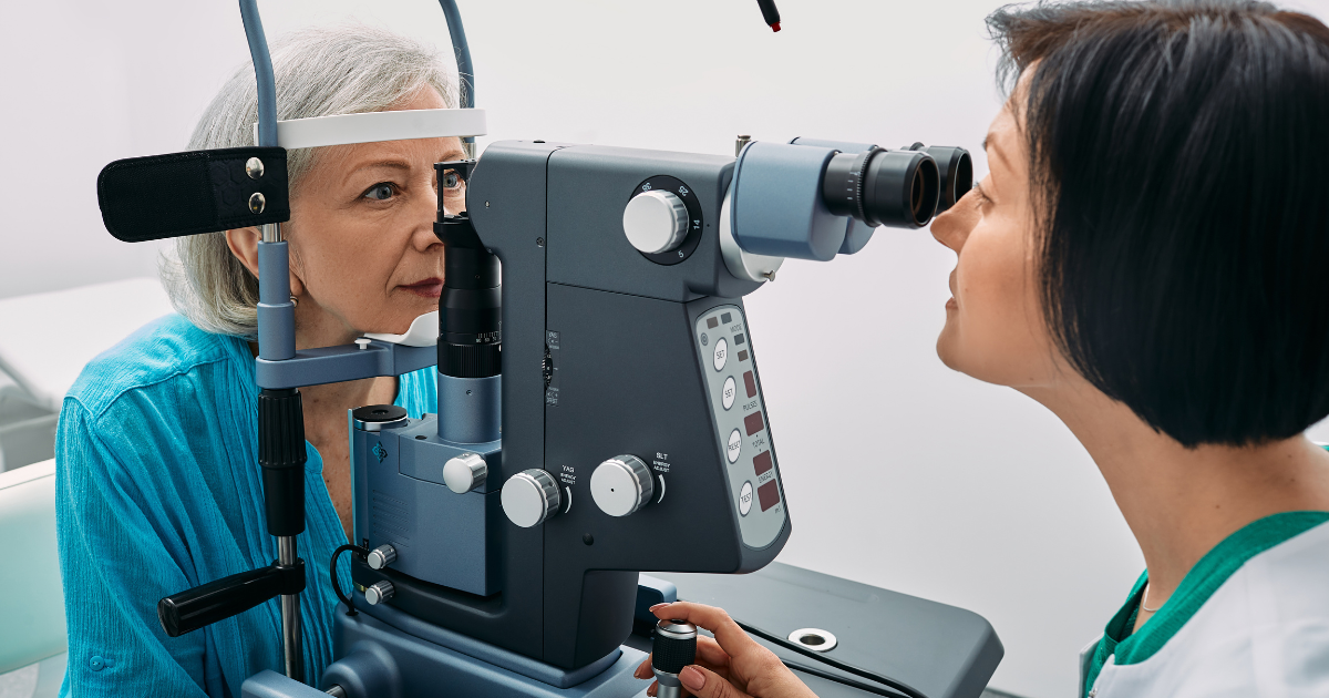 An older woman having her eyes checked for cataracts.