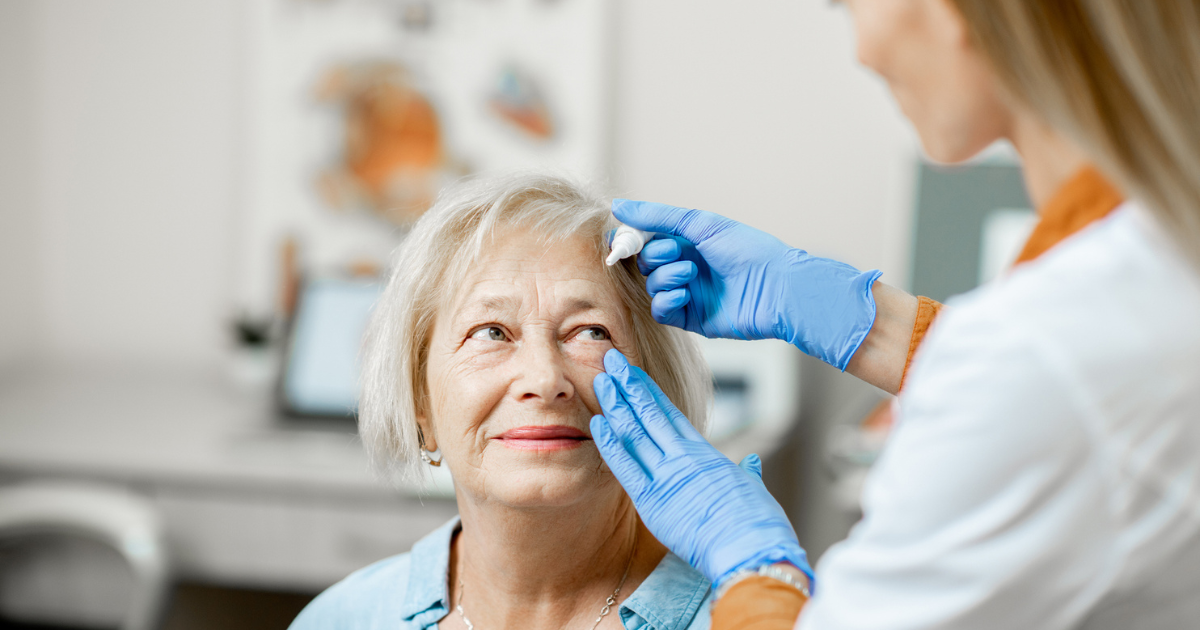 An older woman getting eye drops put in by an eye doctor to help her eye allergies.