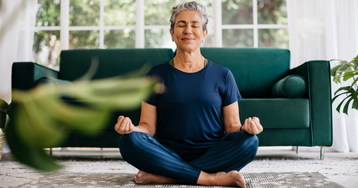 An older woman meditating to mentally prepare for her cataract surgery.
