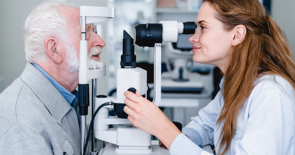 An eye doctor examining a patient's eye for light adjustable lenses.