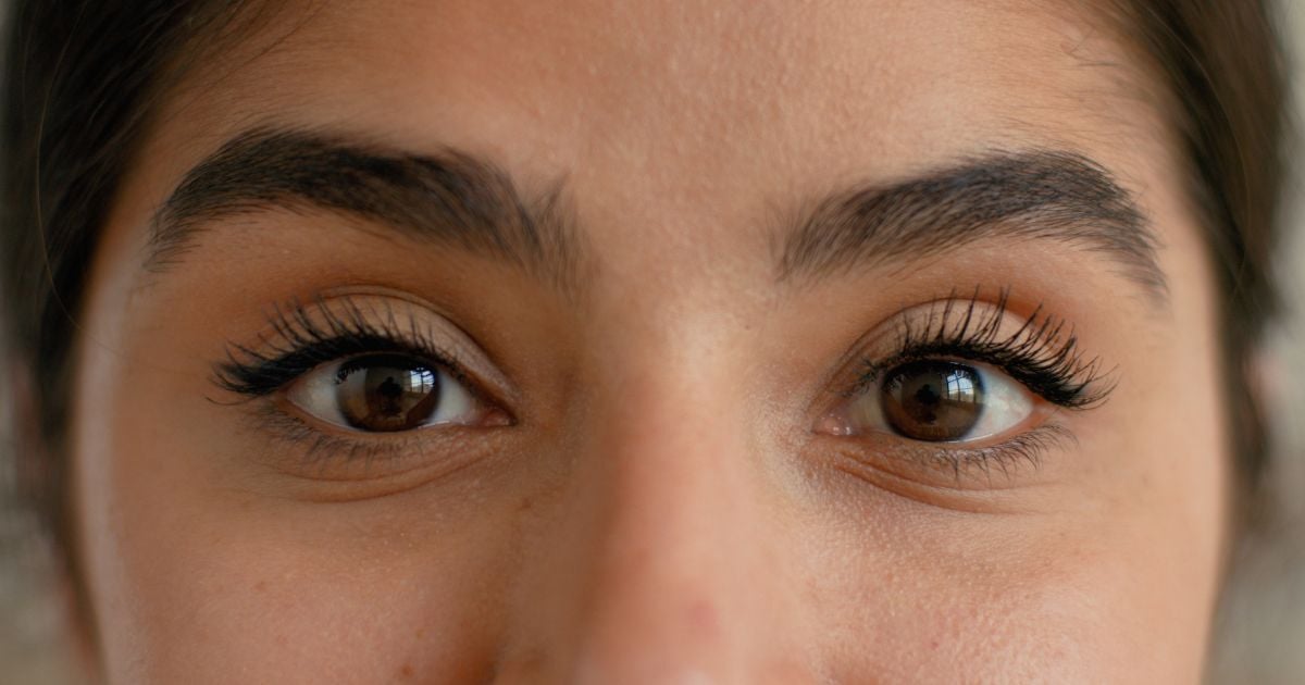 A close up of a woman with dark brown eyes.