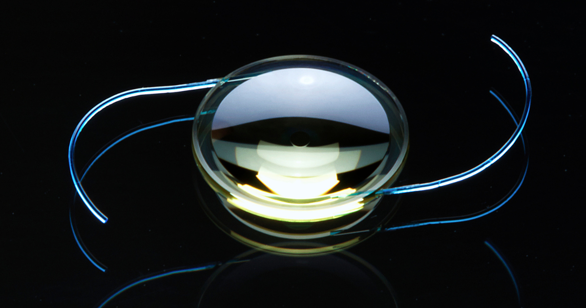 A light adjustable lens used in a cataract surgery against a black background.