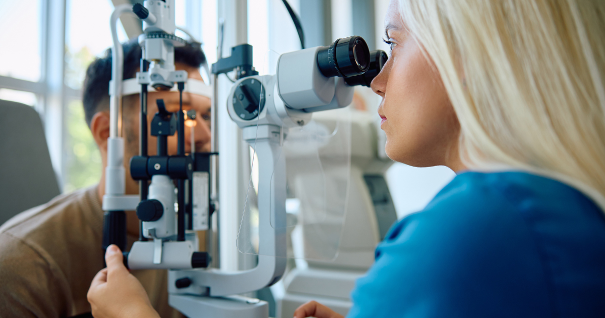 A man receiving an eye exam from an eye doctor.