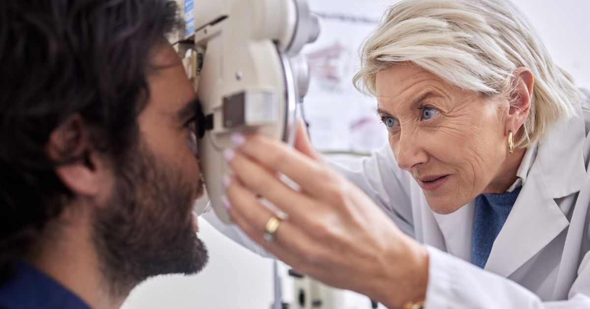 An eye doctor examines her patient's eye for dry eye treatment.