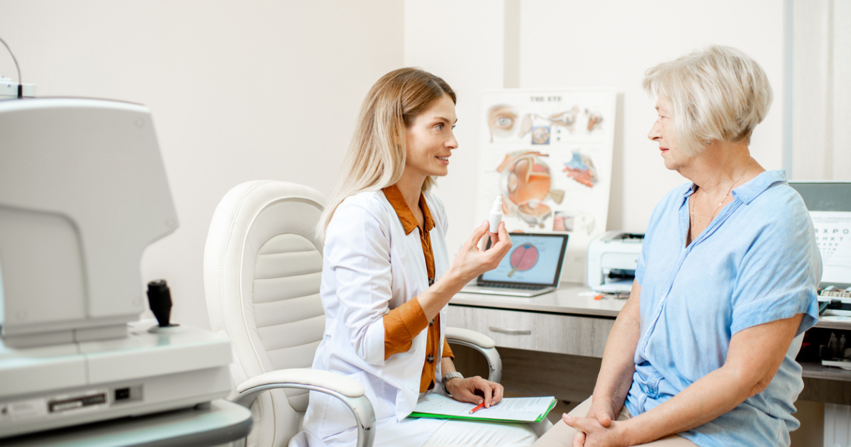 An eye doctor discussing light adjustable lens with a cataract patient.