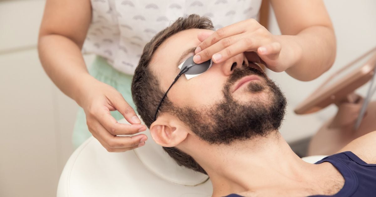 A man having eye protection put on his eyes for IPL dry eye treatment.
