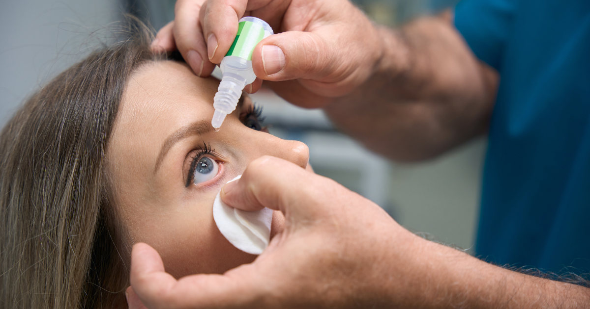 An eye doctor putting prescription eye drops into a patient's eye to help with eye allergies.