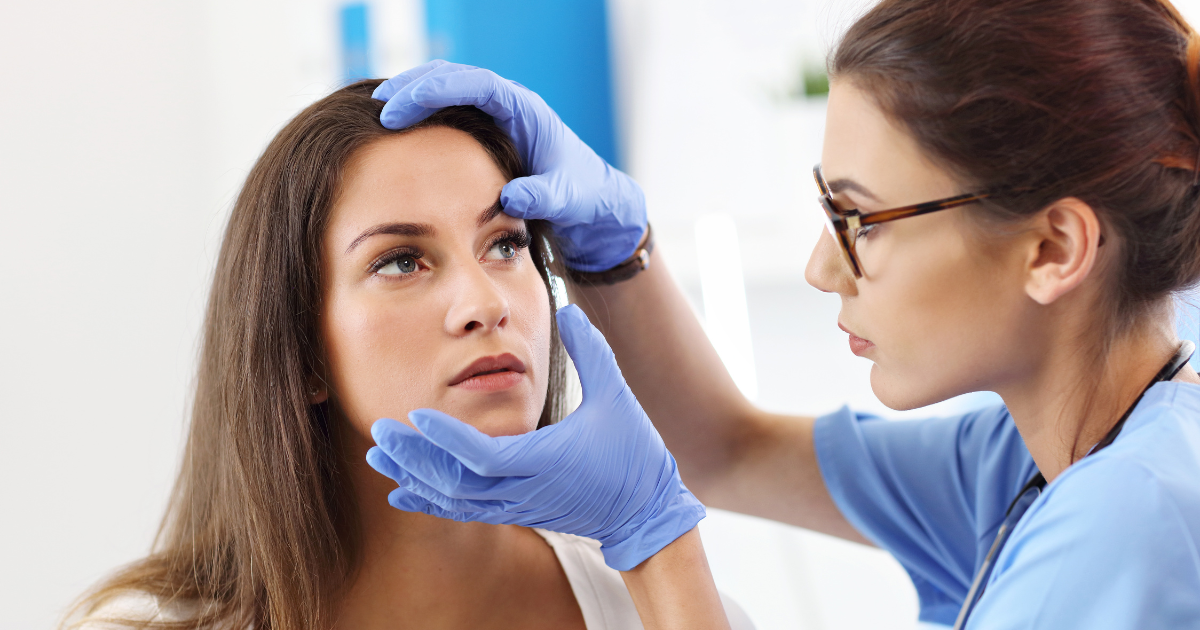 A woman receiving an eye exam for an eye infection.